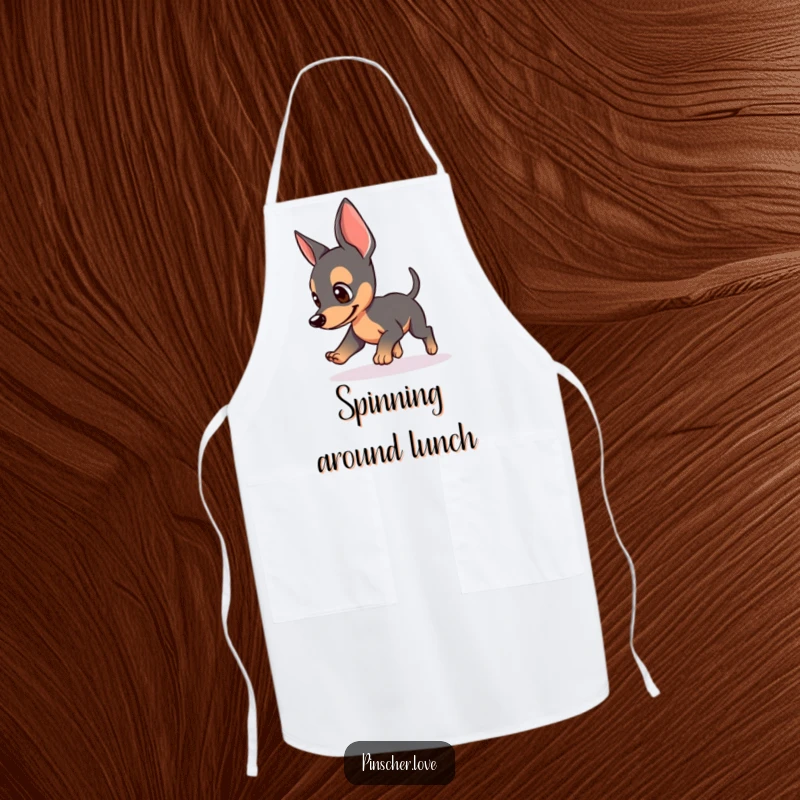 Funny apron featuring a Pinscher dog chasing its tail, perked ears, great for cooking and dog humor lovers, excellent funny gift.