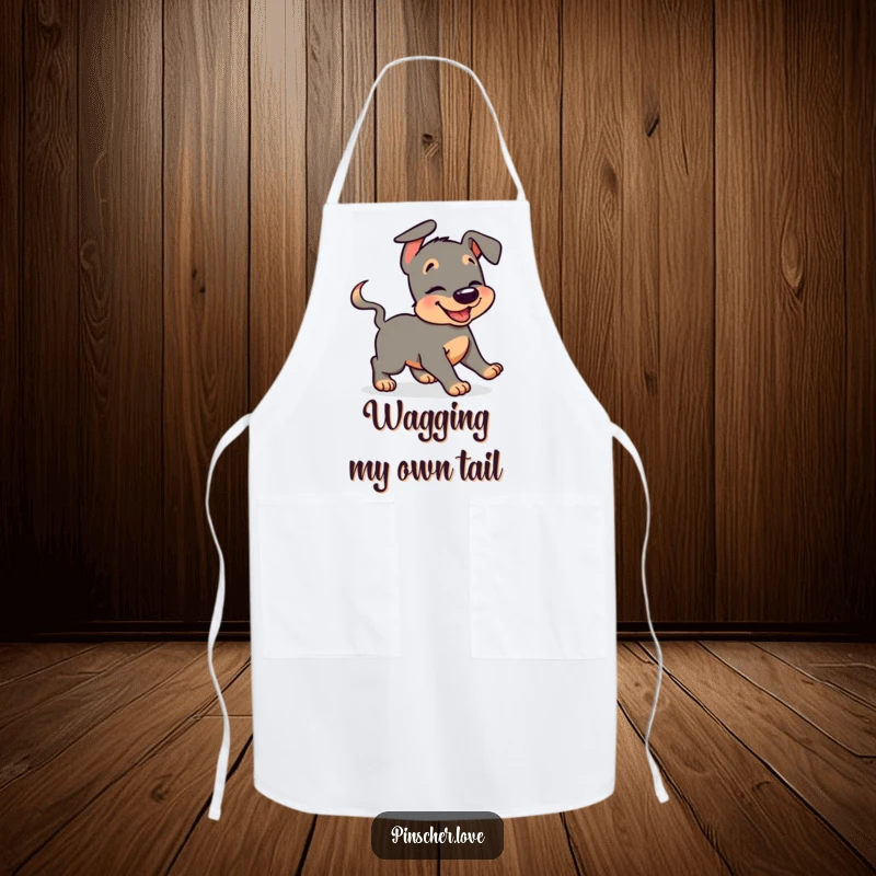 Funny pinscher apron with a giggling dog character humorously chasing its wagging tail, perfect for adding fun to cooking tasks.