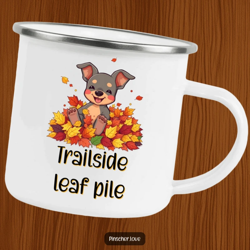 Funny camping mug featuring a pinscher character joyfully rolling in a pile of colorful autumn leaves.