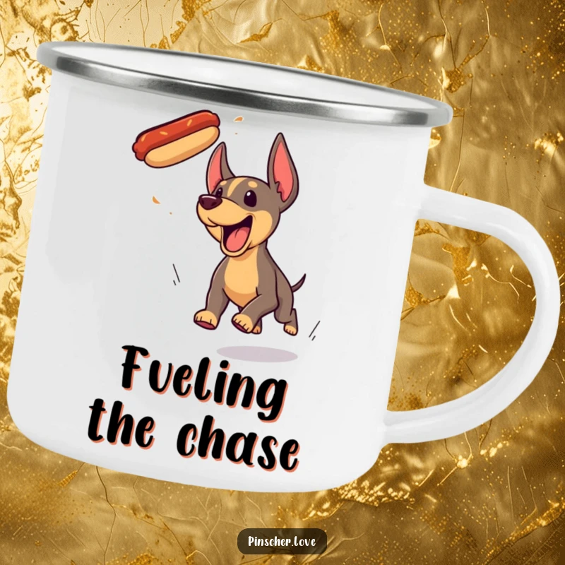 Funny Pinscher dog camping mug, yipping with excitement while chasing a flying hotdog during outdoor adventures.