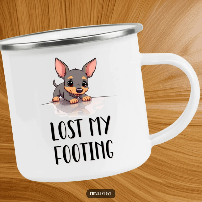 Funny Pinscher Camping Mug depicting a dog hilariously slipping on a slick surface, ready for outdoor fun.