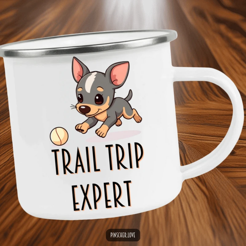 Funny Pinscher camping mug, enamel cup with dog character playfully tripping while chasing a tiny ball, outdoor humor, gift.