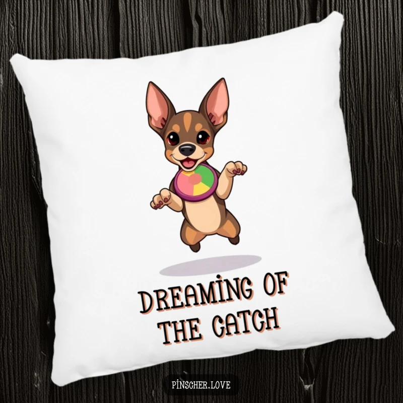 Funny Pinscher pillow showcasing a determined dog poised to leap for a colorful flying disc, adding athletic humor to any room.