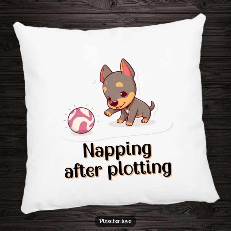 Funny Pinscher Pillow: A mischievous pinscher playfully nudges a bouncing, crinkly ball, offering a soft and humorous addition to any seating.