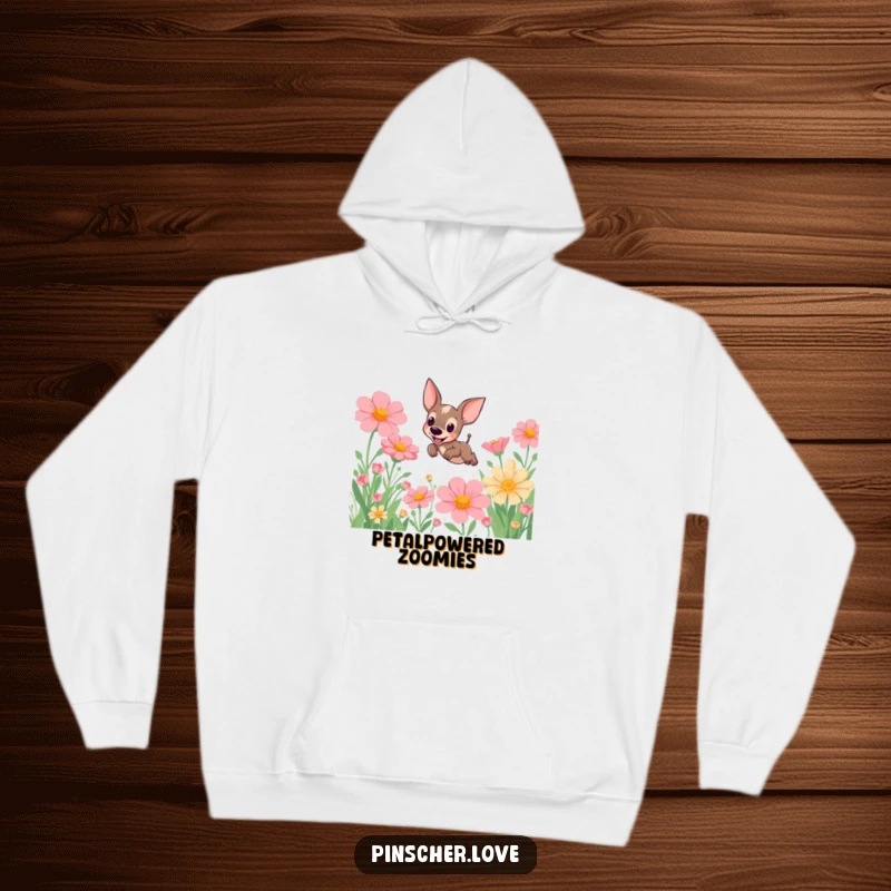 Funny Pinscher Hoodie: A joyful pinscher dog takes a big leap over giant, colorful flowers in a whimsical, sunny meadow, radiating happiness.