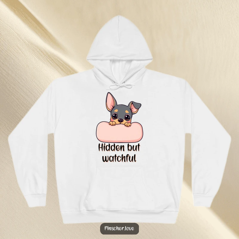 Funny Pinscher hoodie depicting a cute Pinscher dog peeking expectantly from behind a plush cushion, ready for fun.