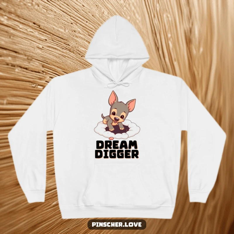 Funny pinscher dog digging in a soft, cloud-like surface, depicted on a comfy hoodie for ultimate relaxation and humor