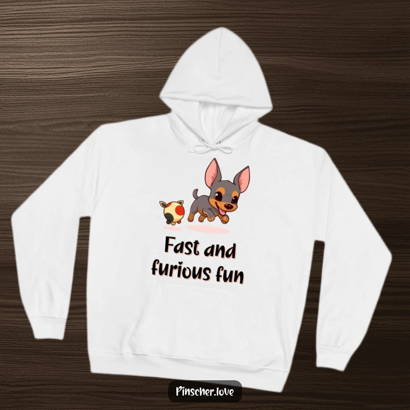 Funny, warm hoodie showcasing an energetic pinscher character determinedly chasing a small, fleeing toy.