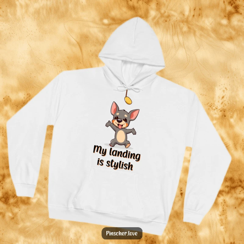 Funny Pinscher Hoodie: A pinscher character comically falls while reaching for a dangling toy, showing a hilarious, relatable moment.