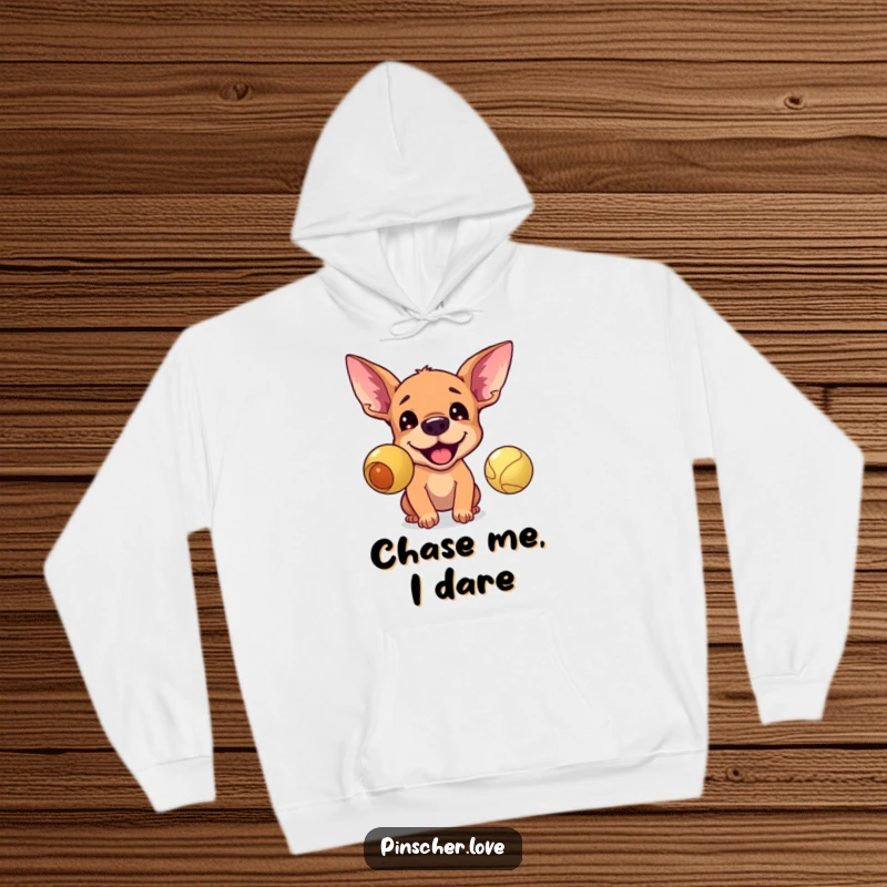 Funny hoodie depicting an excited pinscher with ears up, barking ferociously at a bouncing ball, perfect for dog lovers.