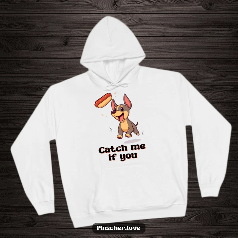 Funny Pinscher dog hoodie, enthusiastically yipping and chasing a rogue flying hotdog with pure, unadulterated glee.