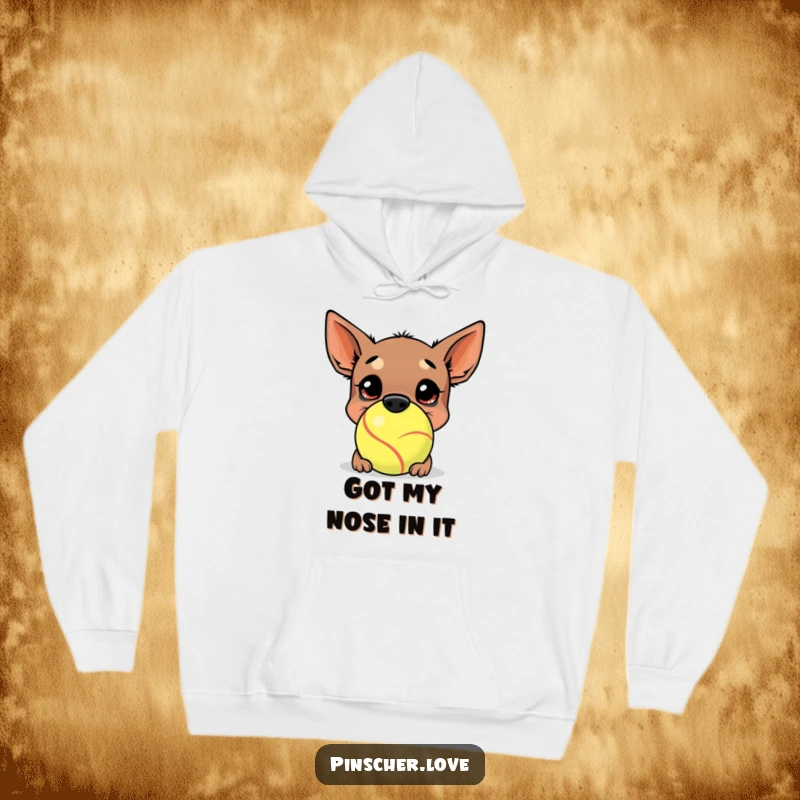 Funny Pinscher Hoodie: A joyful pinscher buries its nose deep within a comically oversized tennis ball, embodying playful obsession and happiness.