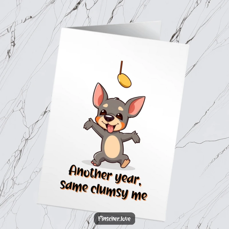 Funny Free Printable Birthday Card: A pinscher hilariously tumbles while trying to grab a dangling toy. Epic fail, happy birthday!