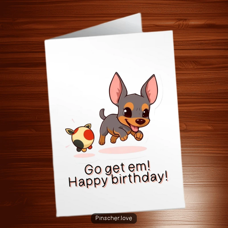 Funny Free Printable Birthday Card of a determined pinscher energetically chasing a small, fleeing toy, celebrating with zest.