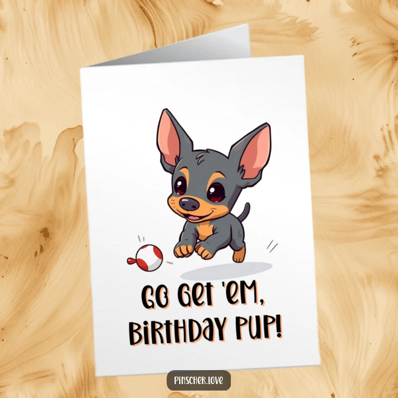 Free Printable Birthday Card: A pinscher character intensely chasing a small, fleeing toy with great determination.