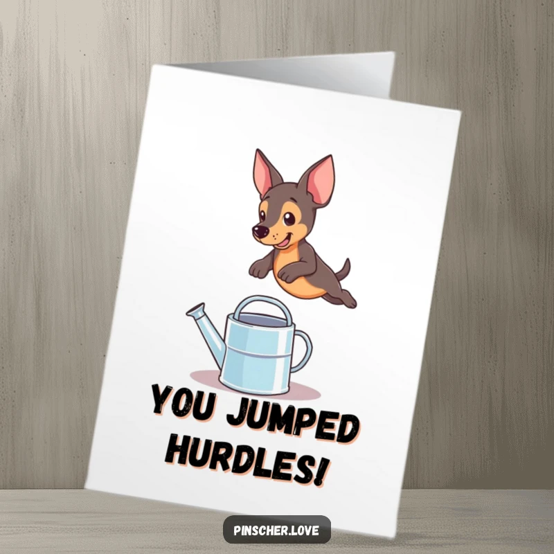 Funny Free Printable Congratulations Card: A pinscher dog triumphantly leaps over a small watering can, celebrating success.