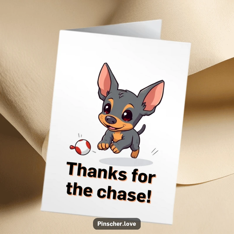 Free Printable Thank You Card: A pinscher character energetically chasing a small, fleeing toy, sending thanks.