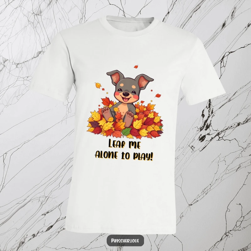 Funny t-shirt featuring a pinscher character joyfully rolling in a pile of colorful autumn leaves.