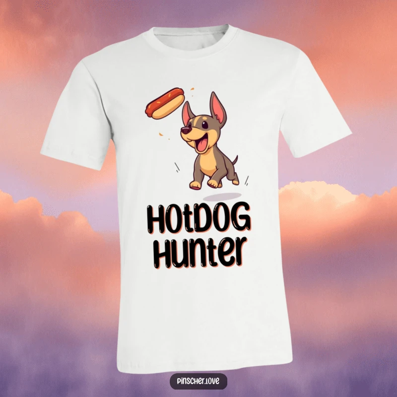 Funny Pinscher dog t-shirt, comically yipping and sprinting after a flying hotdog with boundless energy and joy.