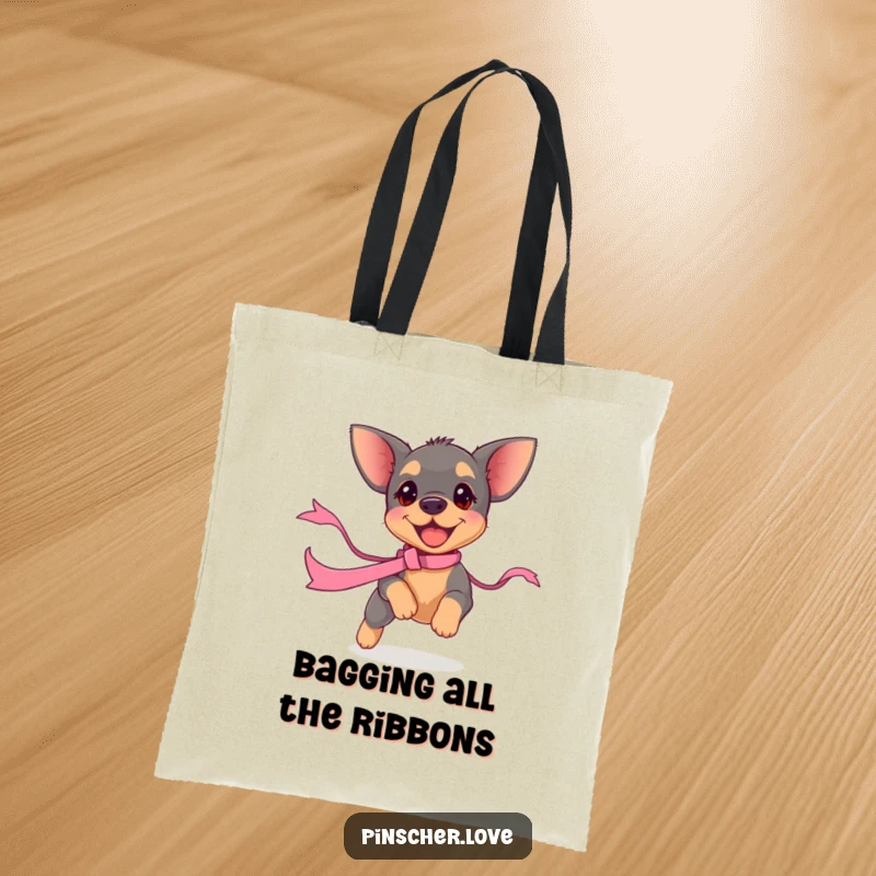 Funny pinscher puppy tote bag, depicting a small dog focused intently on chasing a ribbon. A humorous and practical accessory.