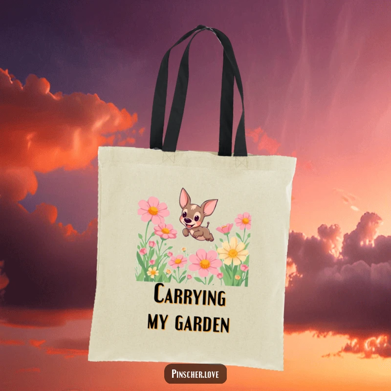 Funny Pinscher Tote Bag: A cute pinscher dog is captured mid-leap in a field of enormous, vibrant flowers, adding humor to your errands.