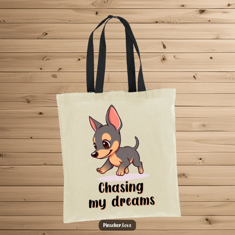 Funny tote bag with a Pinscher dog chasing its tail, perked ears, perfect for shopping and dog-themed humor lovers, great funny gift.