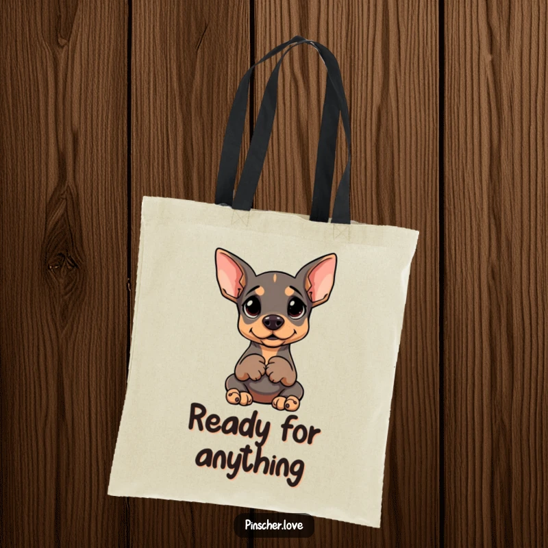 Funny tote bag featuring a Pinscher sitting upright, paws clasped, with a goofy, anticipating expression.