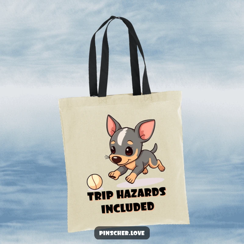 Funny Pinscher tote bag, durable canvas with dog character playfully tripping while chasing a small ball, oops moment, gift.